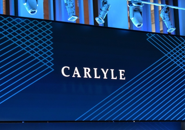 Carlyle logo displayed on a video screen